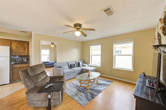 living area with visible vents, baseboards, and light wood-style floors