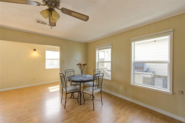 dining space with visible vents, ceiling fan, baseboards, and light wood-style floors