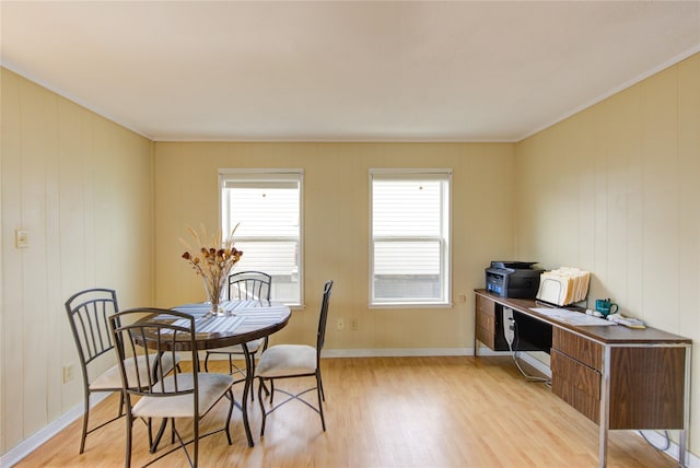 dining area with baseboards and light wood-type flooring