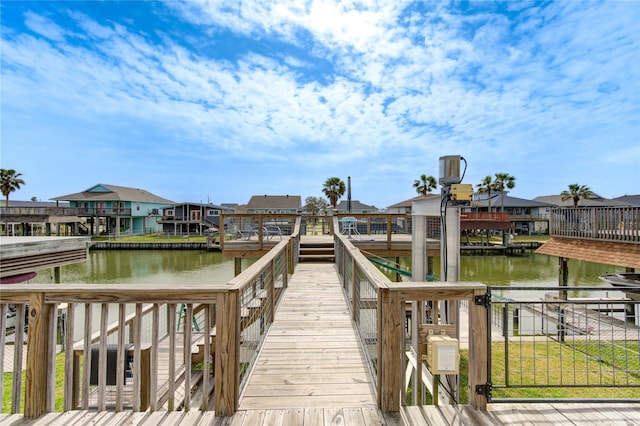 dock area featuring a residential view and a water view