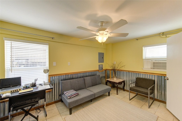 living area with light tile patterned floors, cooling unit, electric panel, and a ceiling fan