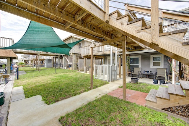 view of yard with a patio, fence, and an outdoor fire pit