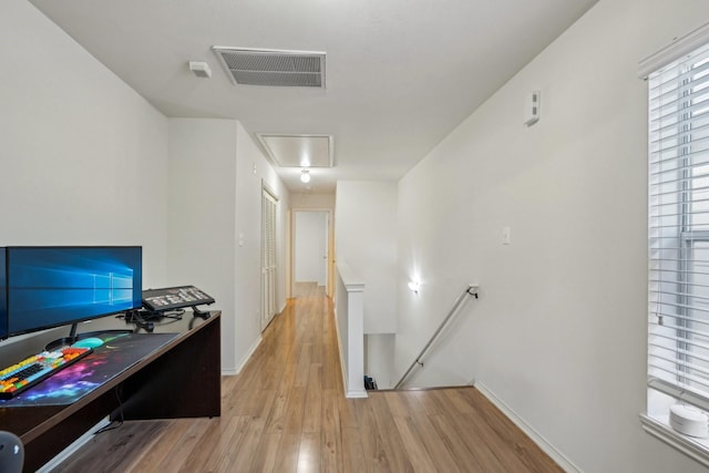 home office featuring visible vents, baseboards, attic access, and wood finished floors