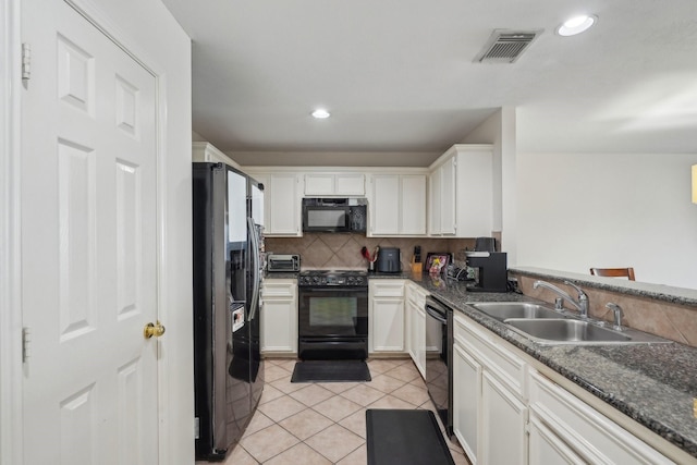 kitchen with tasteful backsplash, visible vents, light tile patterned floors, black appliances, and a sink