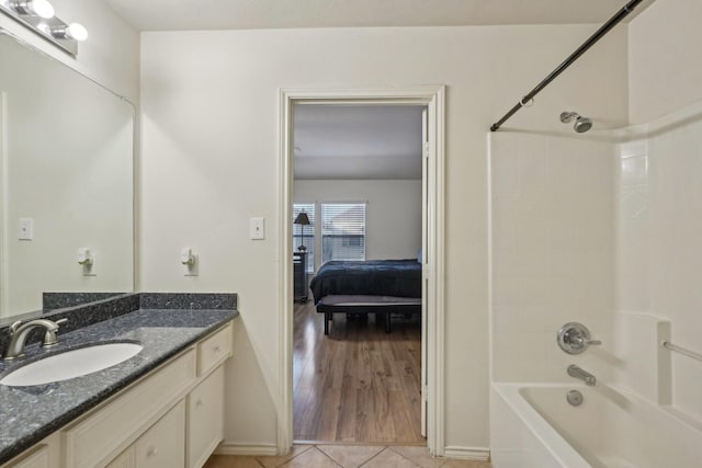 bathroom with tile patterned floors, bathtub / shower combination, and vanity