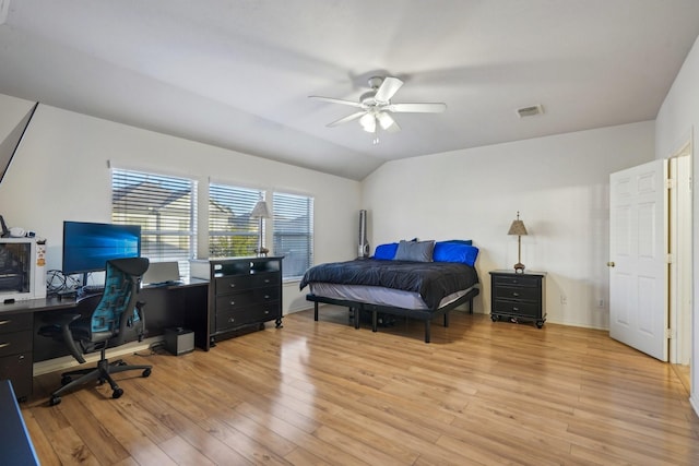 bedroom featuring a ceiling fan, lofted ceiling, visible vents, and light wood-type flooring