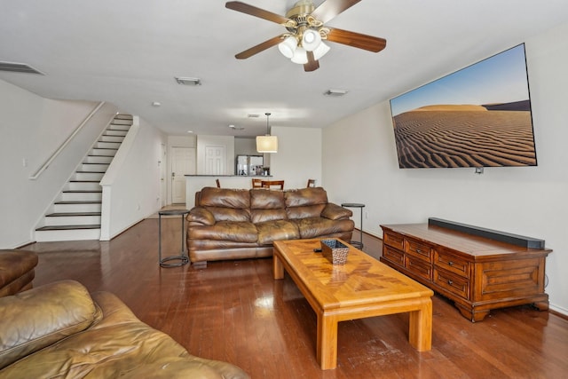 living room with stairway, wood finished floors, and visible vents