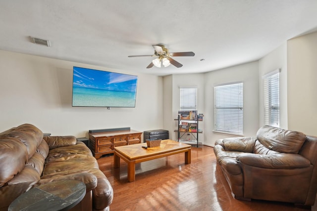 living area with visible vents, wood-type flooring, and ceiling fan