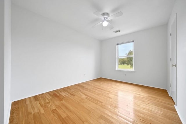 interior space with a ceiling fan, visible vents, and light wood finished floors