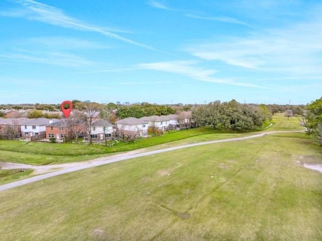 view of property's community with a residential view and a lawn