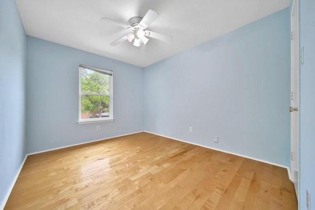 spare room featuring light wood finished floors and ceiling fan