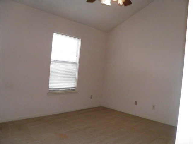 unfurnished room featuring a ceiling fan and vaulted ceiling