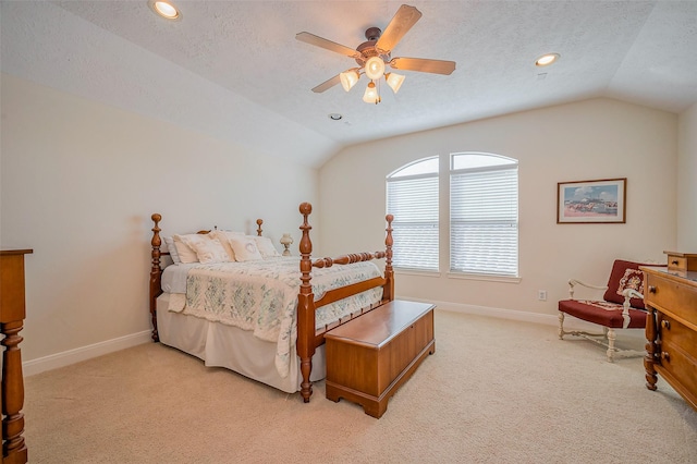 bedroom featuring light carpet, a textured ceiling, and vaulted ceiling