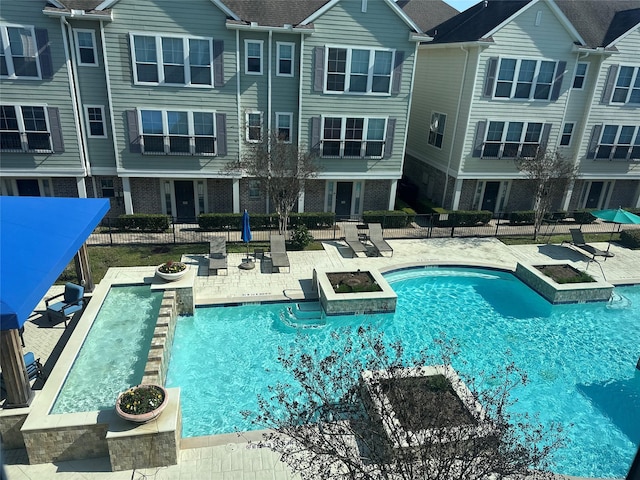 pool featuring a patio area and fence