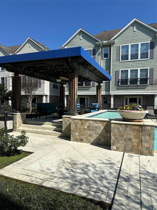 exterior space with a swimming pool and a patio area