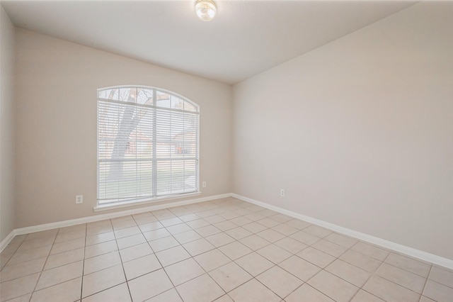 spare room featuring baseboards