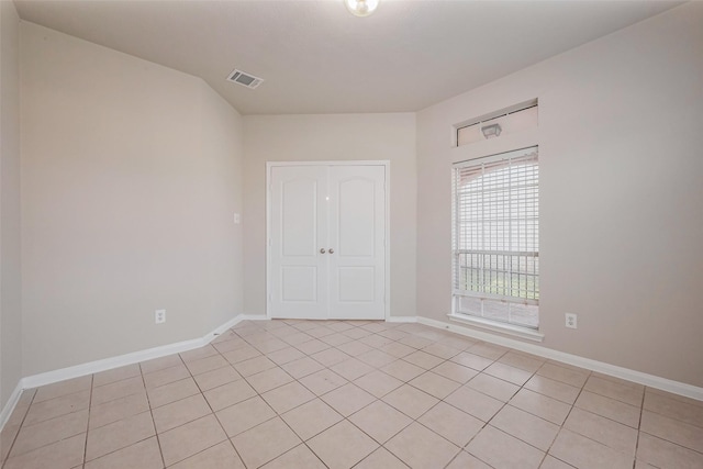 unfurnished room featuring visible vents and baseboards