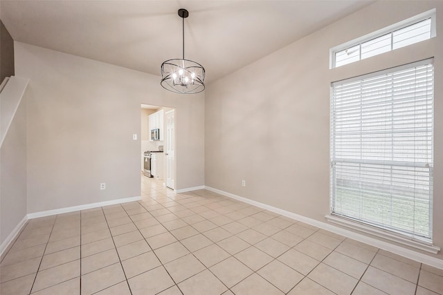 unfurnished dining area featuring light tile patterned floors, baseboards, and an inviting chandelier