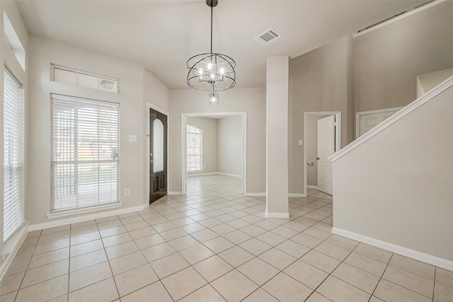 unfurnished room with light tile patterned flooring, a healthy amount of sunlight, and visible vents