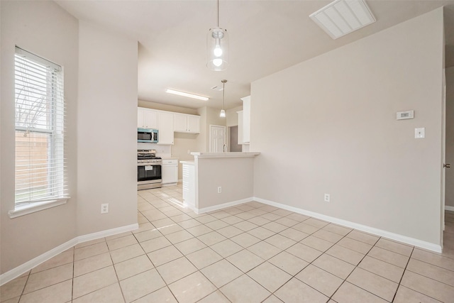 kitchen with visible vents, baseboards, light tile patterned floors, appliances with stainless steel finishes, and white cabinetry