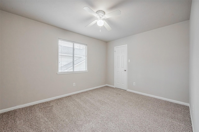 unfurnished room with ceiling fan, baseboards, and light carpet