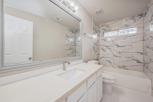 bathroom featuring visible vents, toilet, vanity, and bathtub / shower combination