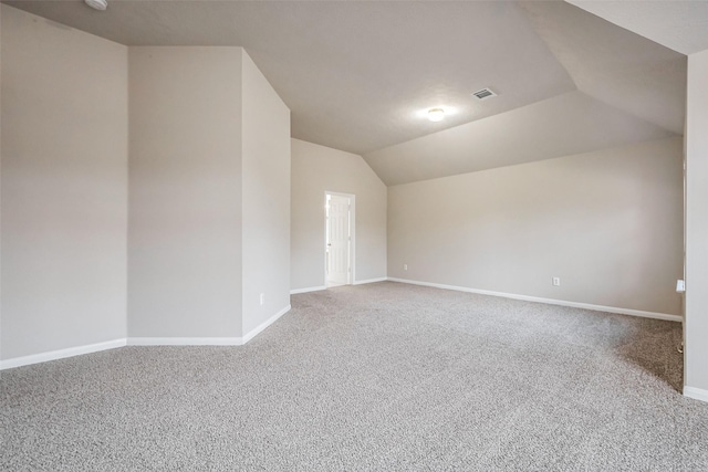 bonus room featuring visible vents, baseboards, lofted ceiling, and carpet floors