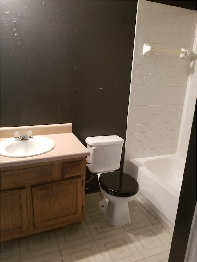 bathroom featuring tile patterned flooring, toilet, and vanity