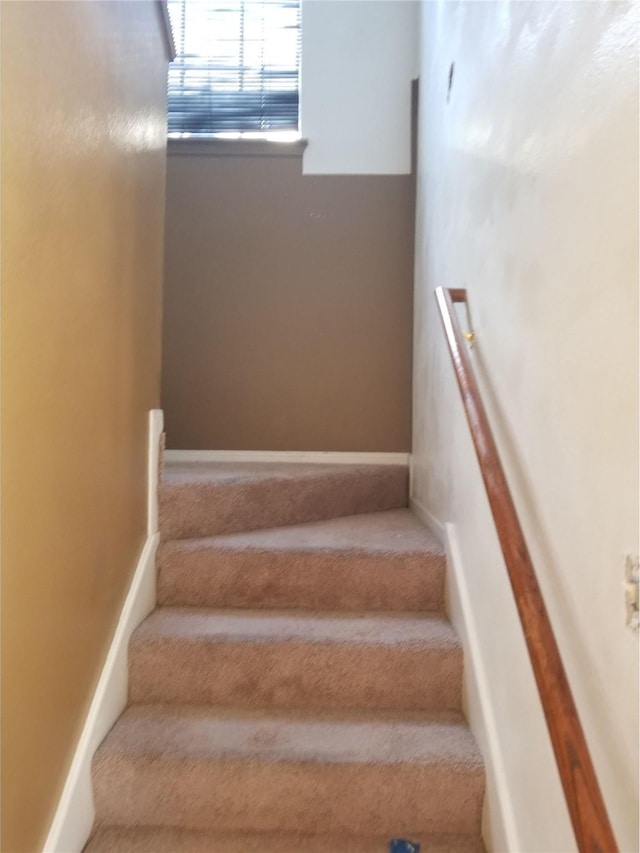 staircase featuring baseboards