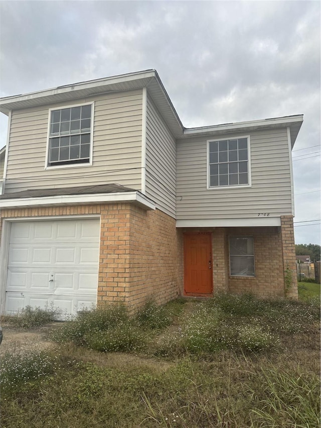 view of front of house featuring brick siding and an attached garage