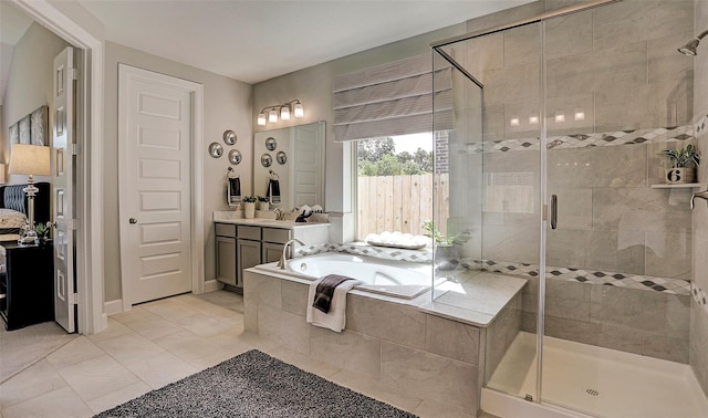 full bathroom featuring a bath, tile patterned floors, a stall shower, and vanity