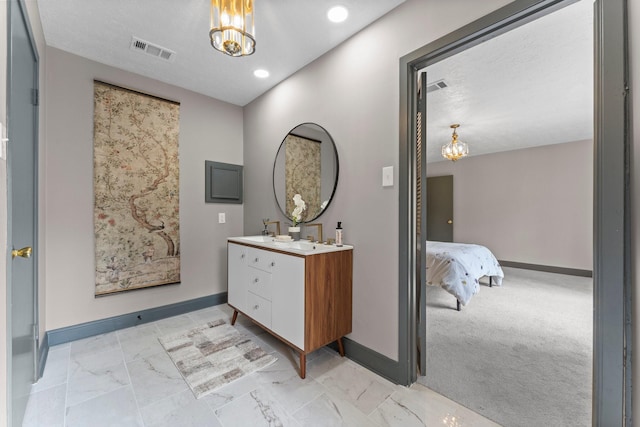 ensuite bathroom featuring visible vents, baseboards, marble finish floor, and vanity