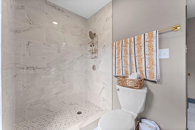 bathroom featuring toilet and tiled shower