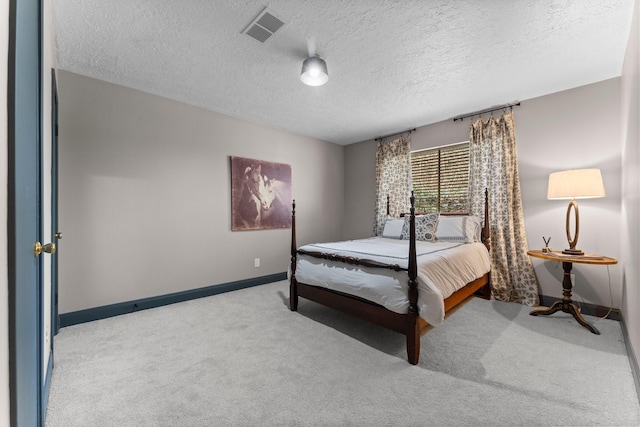 bedroom with visible vents, baseboards, a textured ceiling, and carpet flooring