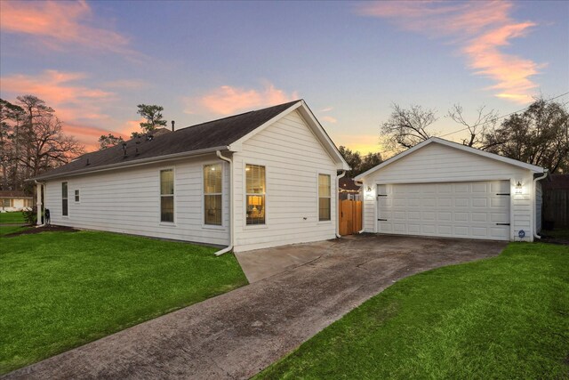 4113 Ella Blvd, Houston, TX 77018 - view of side of home with a detached garage, a yard, an outbuilding, and fence