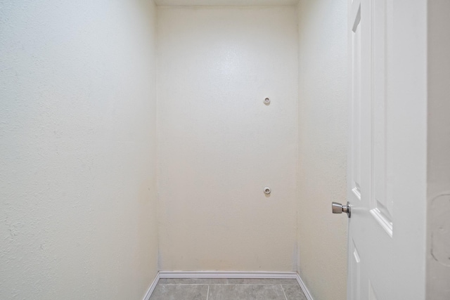 laundry area featuring baseboards