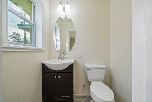 half bathroom with vanity and toilet