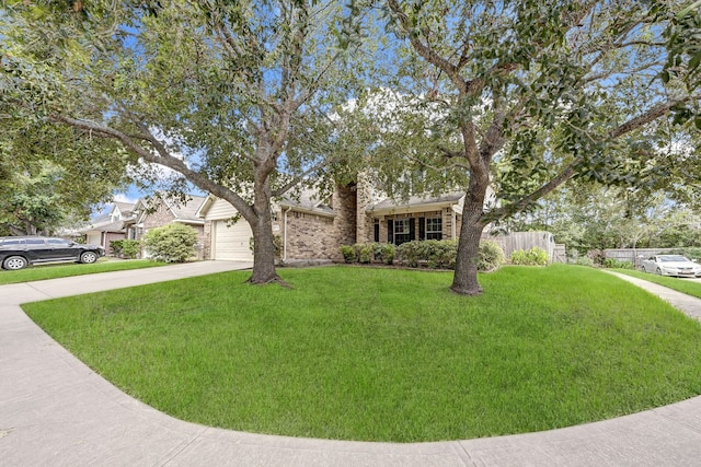 view of front of home with concrete driveway, brick siding, a garage, and a front lawn