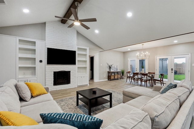 living room featuring wood finished floors, beam ceiling, a fireplace, recessed lighting, and french doors