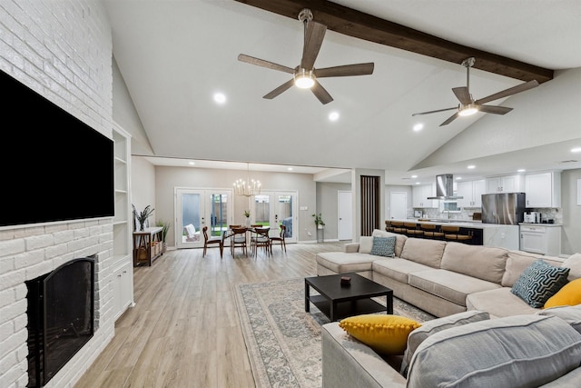 living room featuring beam ceiling, high vaulted ceiling, ceiling fan with notable chandelier, light wood-style floors, and a fireplace