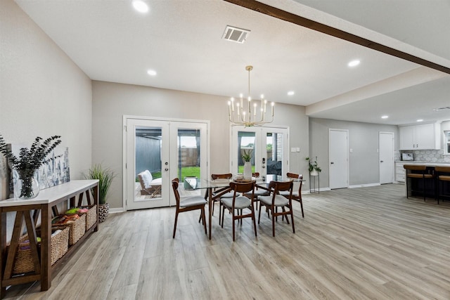 dining room with french doors, visible vents, light wood finished floors, and baseboards