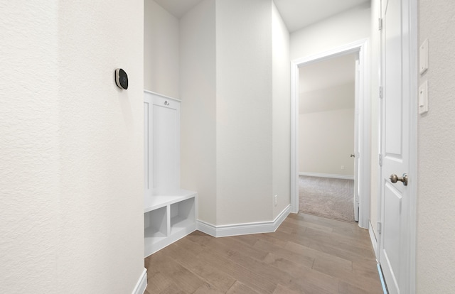 mudroom with baseboards and light wood-type flooring