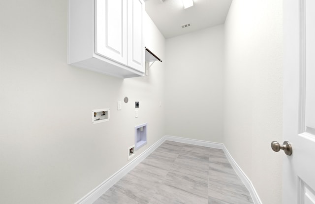 laundry area featuring visible vents, baseboards, hookup for a washing machine, cabinet space, and electric dryer hookup