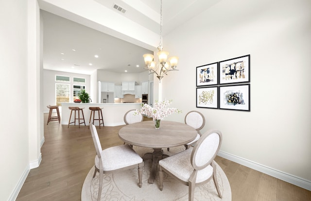 dining space featuring baseboards, visible vents, recessed lighting, light wood-type flooring, and a chandelier