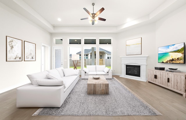 living area with ceiling fan, baseboards, recessed lighting, wood finished floors, and a glass covered fireplace