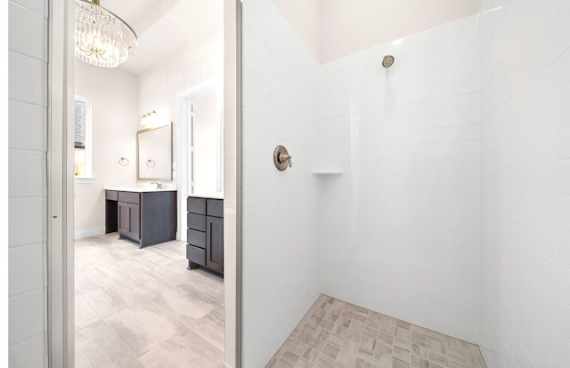 full bathroom with vanity and tiled shower