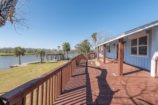 wooden deck featuring a yard and a water view