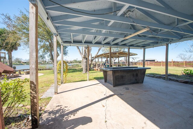 view of patio featuring a carport and fence