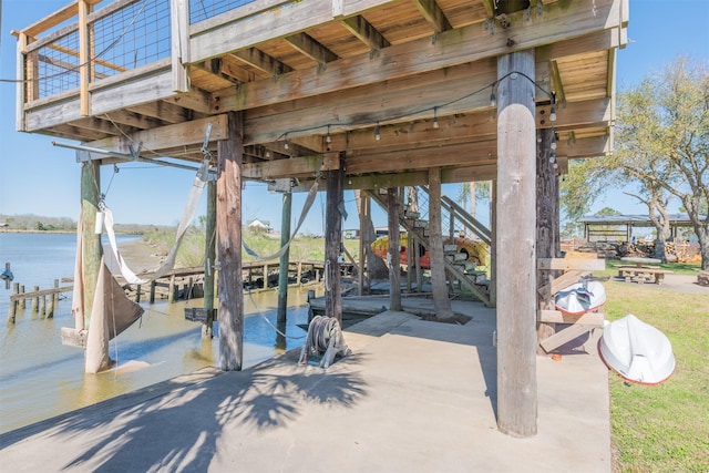 view of property's community with boat lift, a boat dock, and a water view