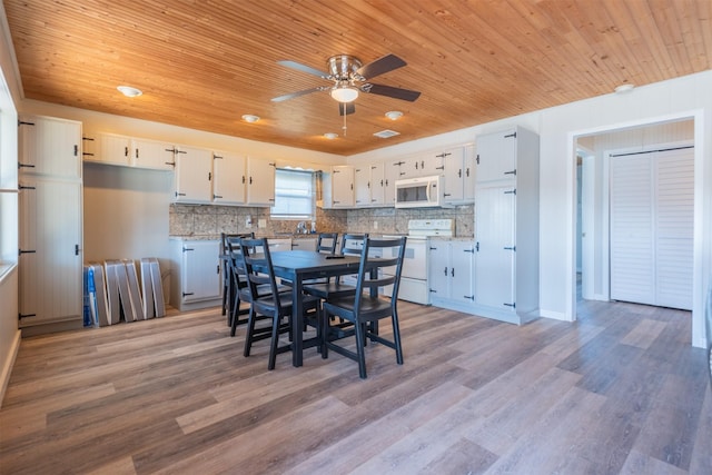 unfurnished dining area featuring wooden ceiling, a ceiling fan, and light wood finished floors